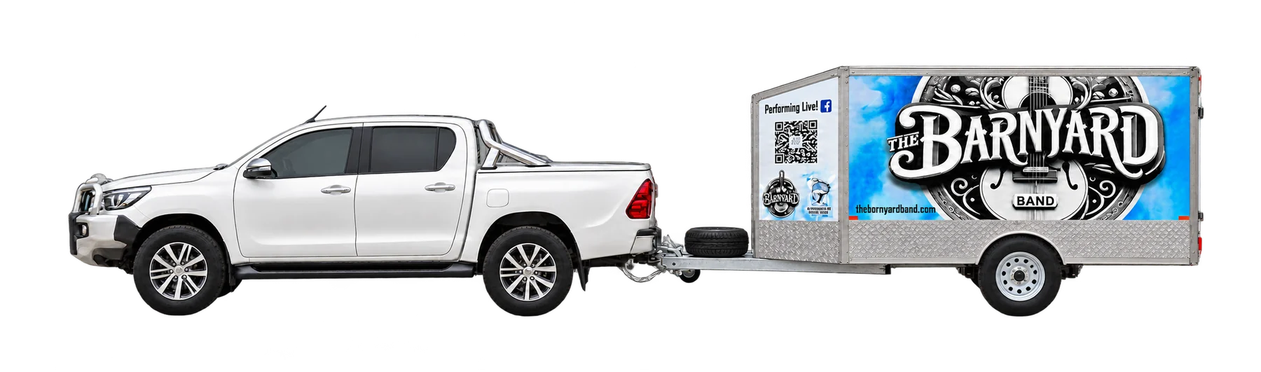 The Barnyard Band Hilux towing the branded trailer, side view
